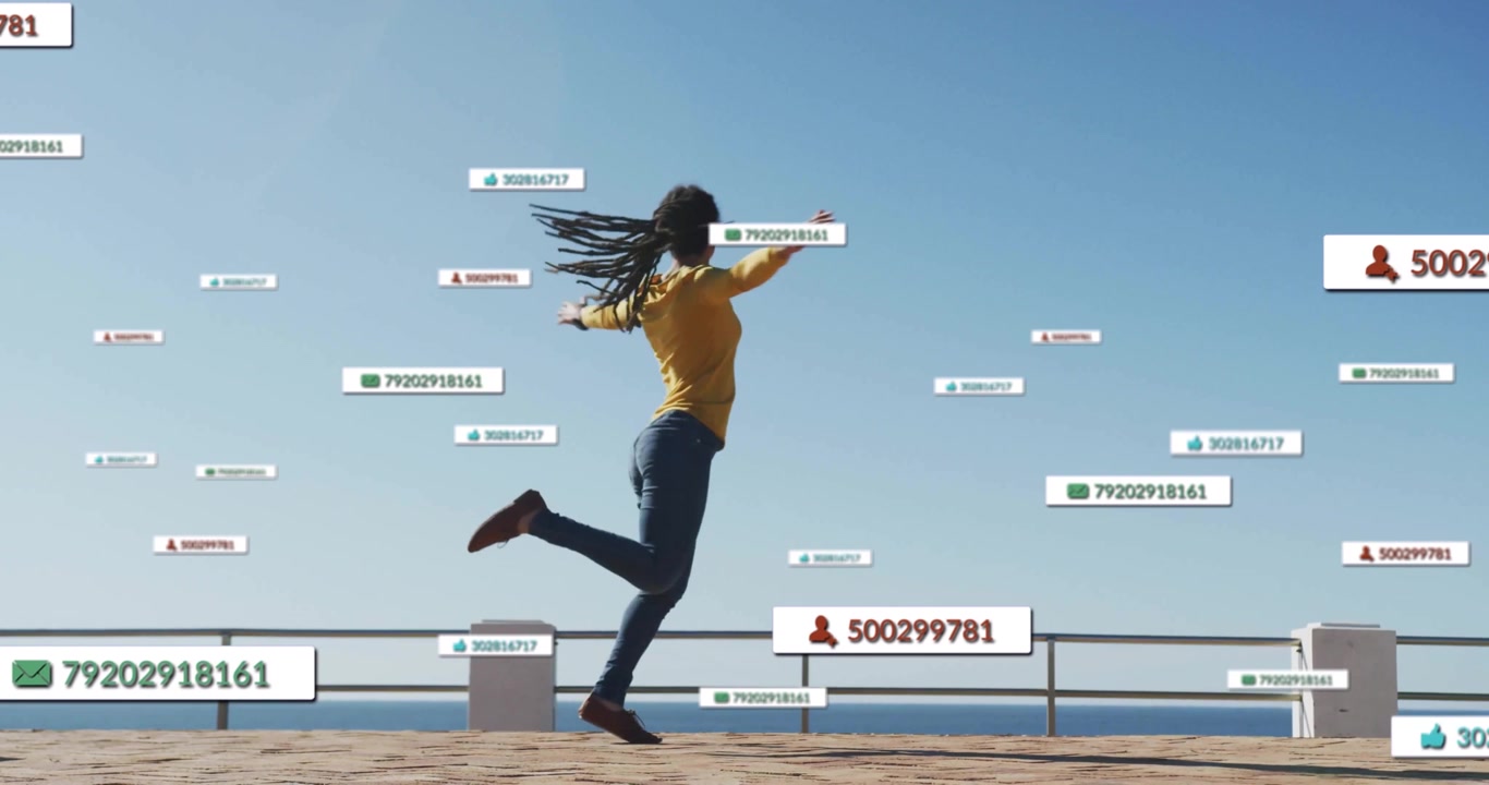 Woman on seaside seeing floating technology tags, extending arm, leaping, spinning and walking