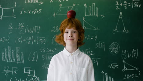 little boy with apple on his head.