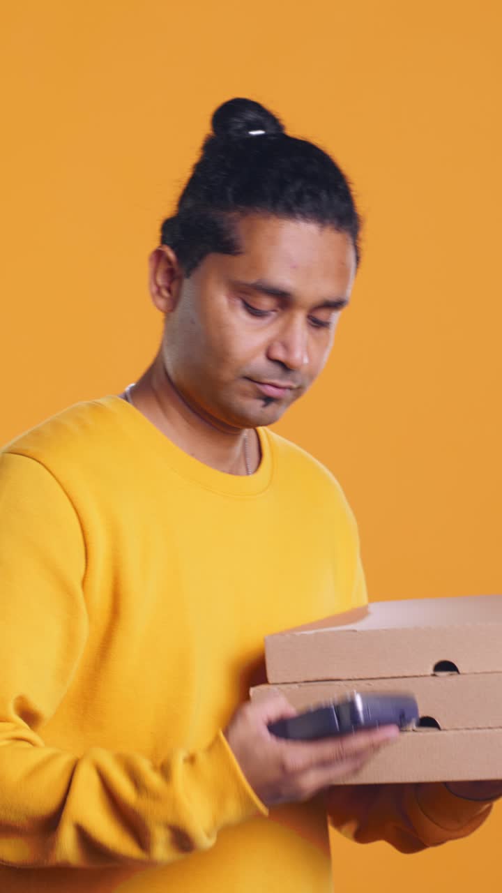 Delivery Man Stacking Pizza Boxes and Taking Payment