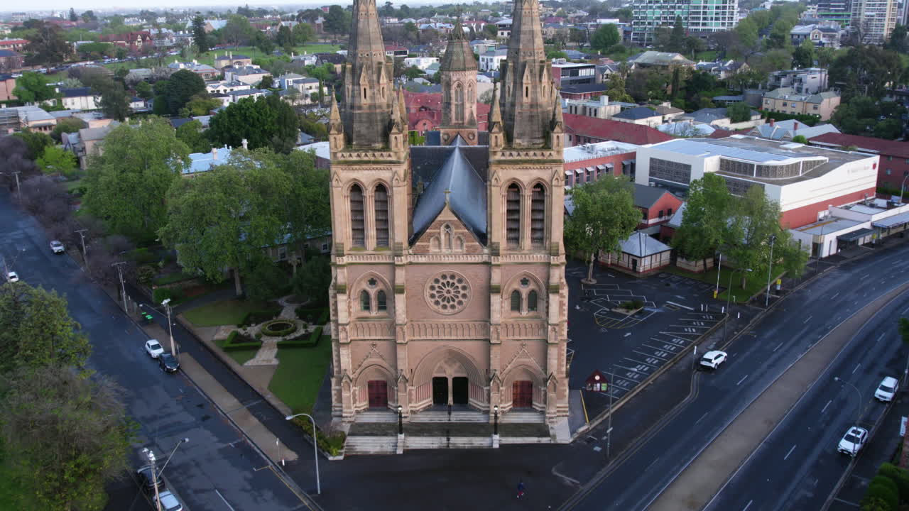 Aerial view rising in front of the St Peter's Cathedral, golden hour in Adelaide