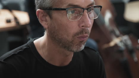 close up of adult jazz pianist at recording studio