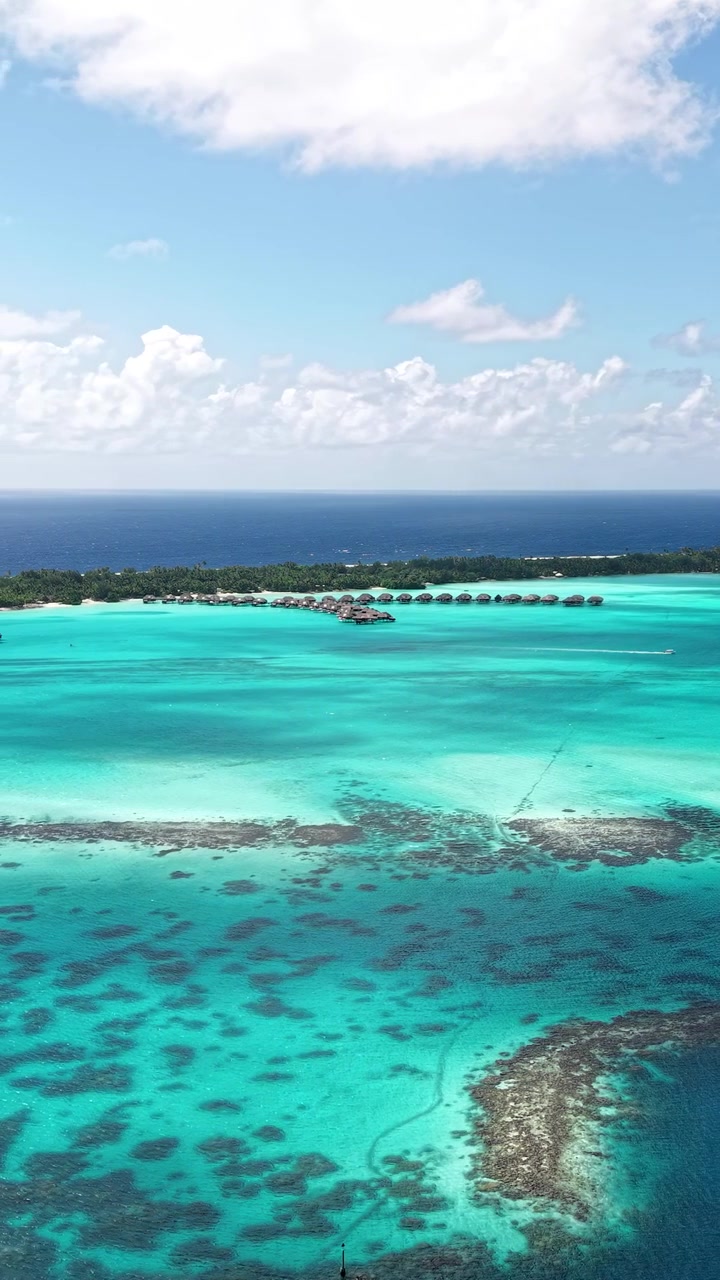 Bora Bora, French Polynesia. Vertical Drone View of Lagoon and Luxury Villas Over Water