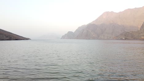 drone clip of inlet in oman leading out to sea at sunset
