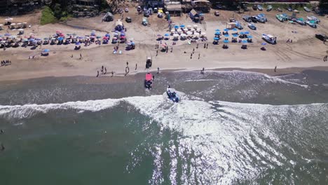 a boat beaches itself to be hauled into shore at the beach in sayulita mexico