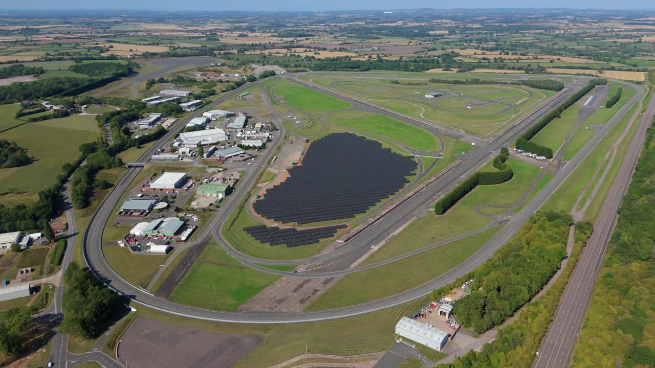 Drone video capturing motor industry test track with renewable energy solar panels and testing facility in England UK