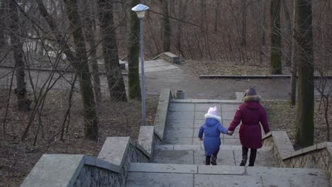 people walk gloomy park in january