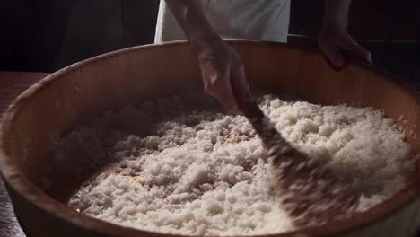 chef steams rice in traditional way