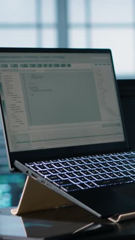 vertical video data center engineer coding on notebook, adjusting power settings