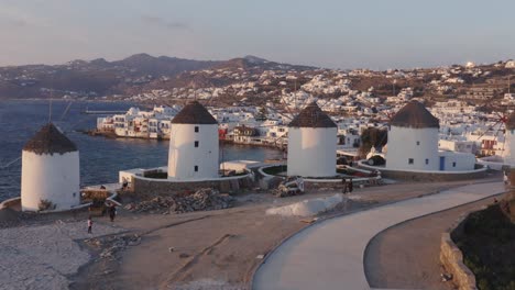 reveal of mykonos town and little venice behind windmills