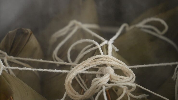 Cooking zongzi food - preparing and steaming Chinese rice dumpling.