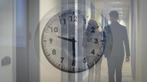 animation of ticking clock against rear view of businessman and businesswoman walking in office