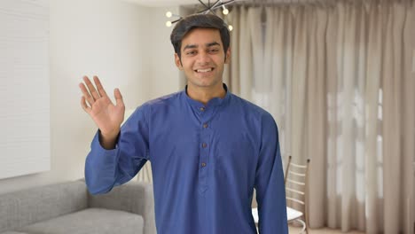 cute indian boy saying hello