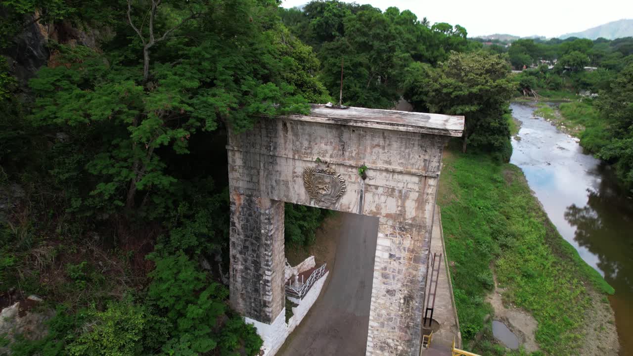 Bird's-eye view of historic arch and Guarico River in lush Venezuela