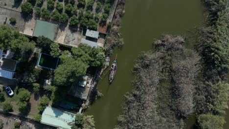 aerial view of river and residential area with boat