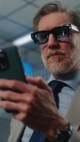 man in a suit using a smartphone