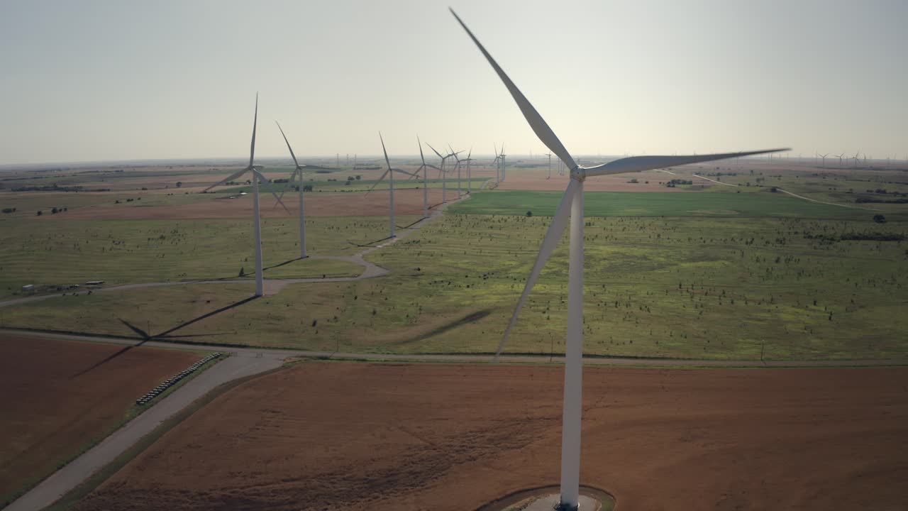 A row of wind turbines spinning to generate electrical power in Oklahoma