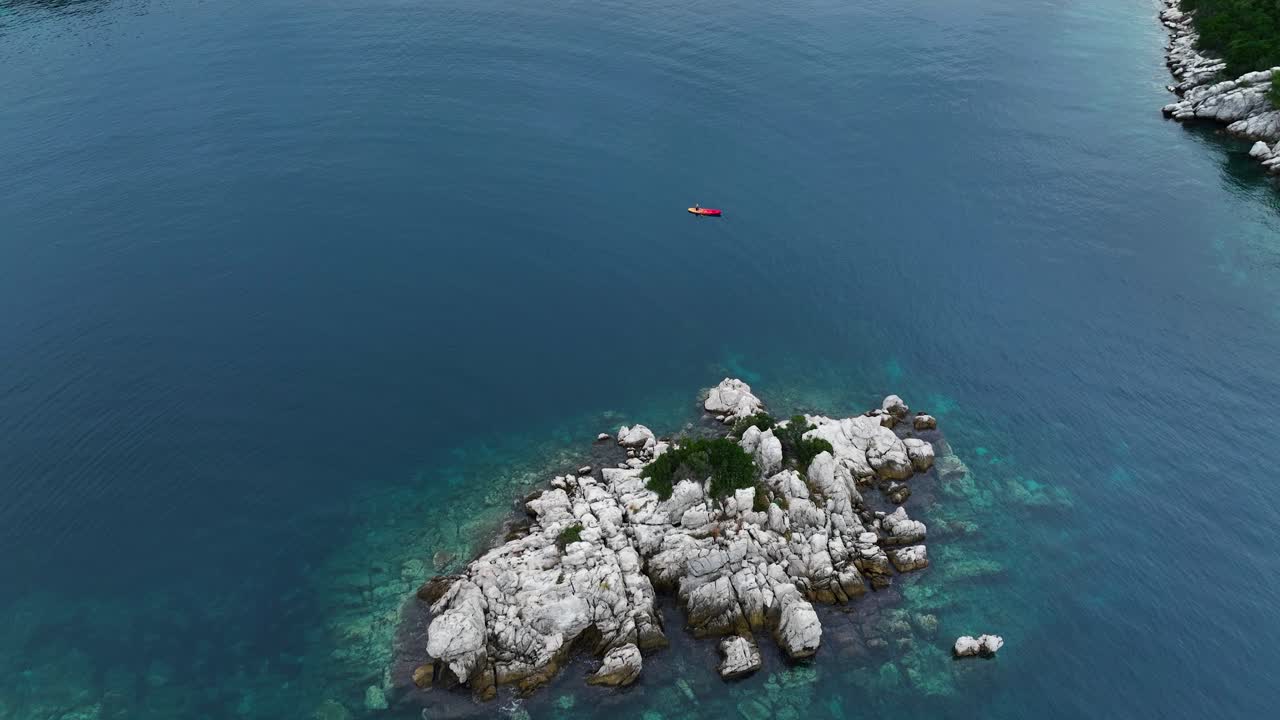 Rocky Islet On Adriatic Sea Near Mljet Island In Dalmatia, Croatia. aerial orbiting shot