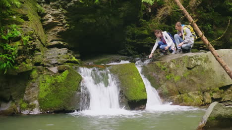 a pair of young tourists enjoy nature in the forest near a small hd video