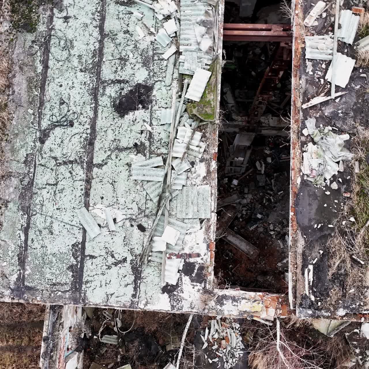 Debris left from an old industrial plant. Top aerial view of destroyed factory. Circle movement around the place