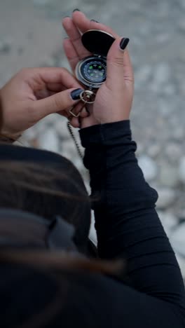 person using a vintage compass outdoors