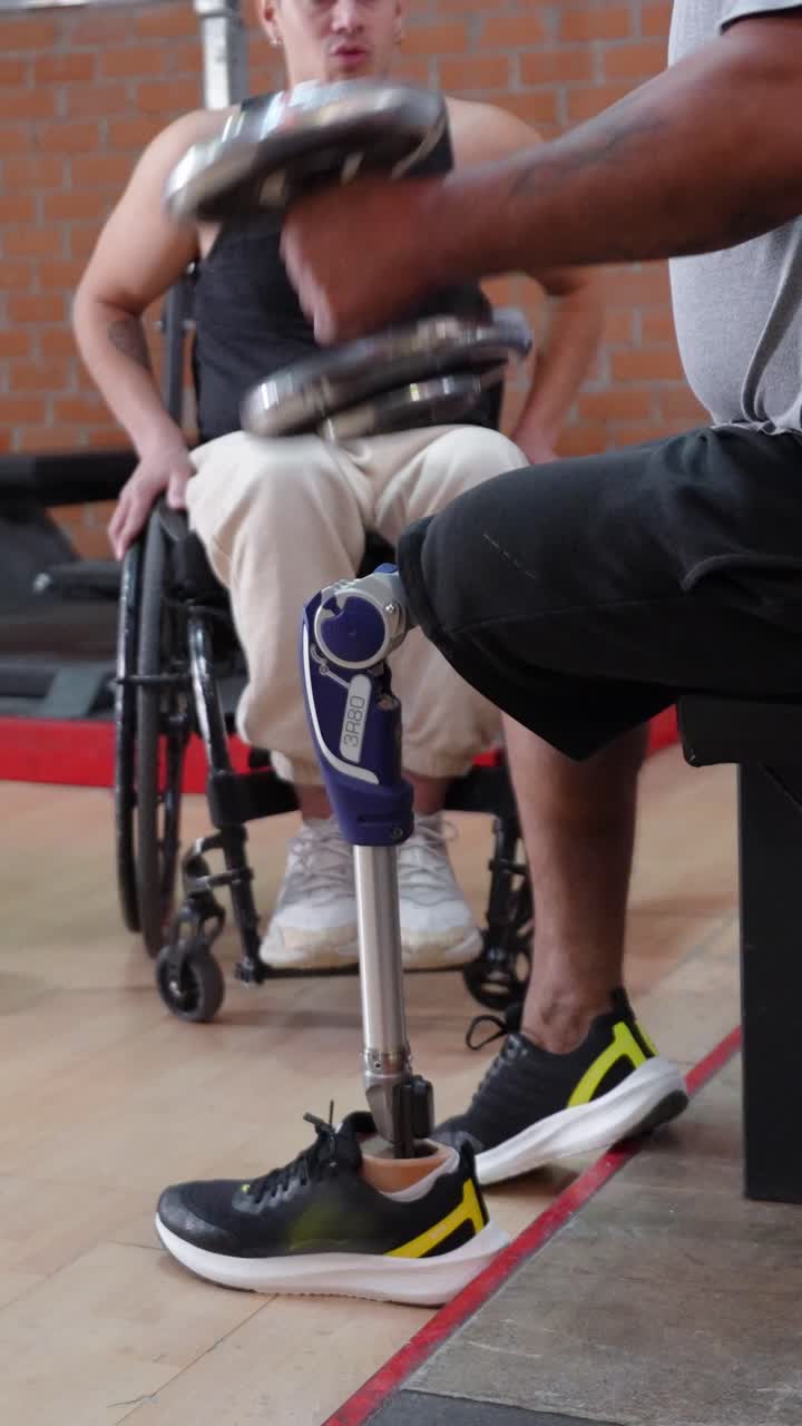 Man with Prosthetic Leg Lifting Weights in Gym with Friend