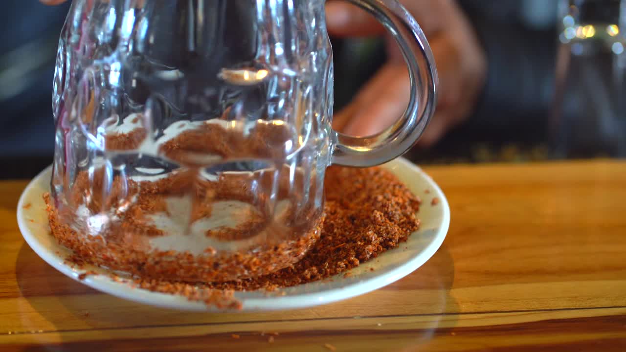 Preparing glass for michelada. Preparing glass for drink in bar.