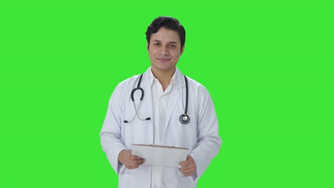 Happy-Indian-doctor-listening-to-patient-Green-screen