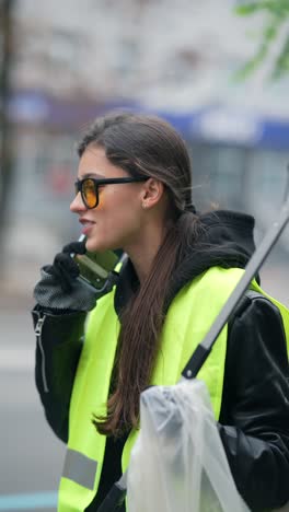 young woman cleaning the streets