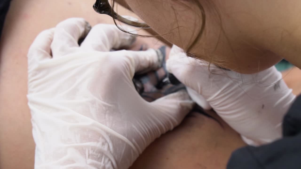 Close-up of a Tattoo Artist Applying a Tattoo