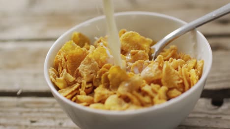 video of cereals in ceramic bowl on wooden kitchen worktop