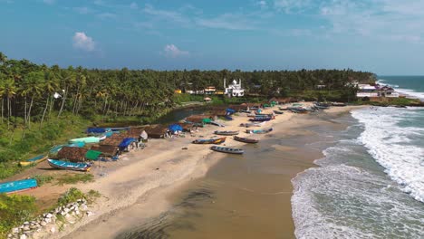 aerial view of fishing village with many boats moored on the beach sand - varkala, kerala, south india