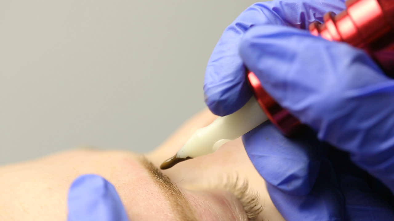 Cosmetician working eyebrow make up at beauty-farm