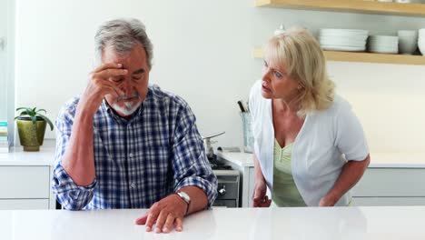 Unhappy-senior-couple-arguing-in-kitchen