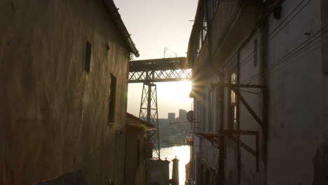train crossing on dom luis i bridge at sunset in porto, portugal. wide shot
