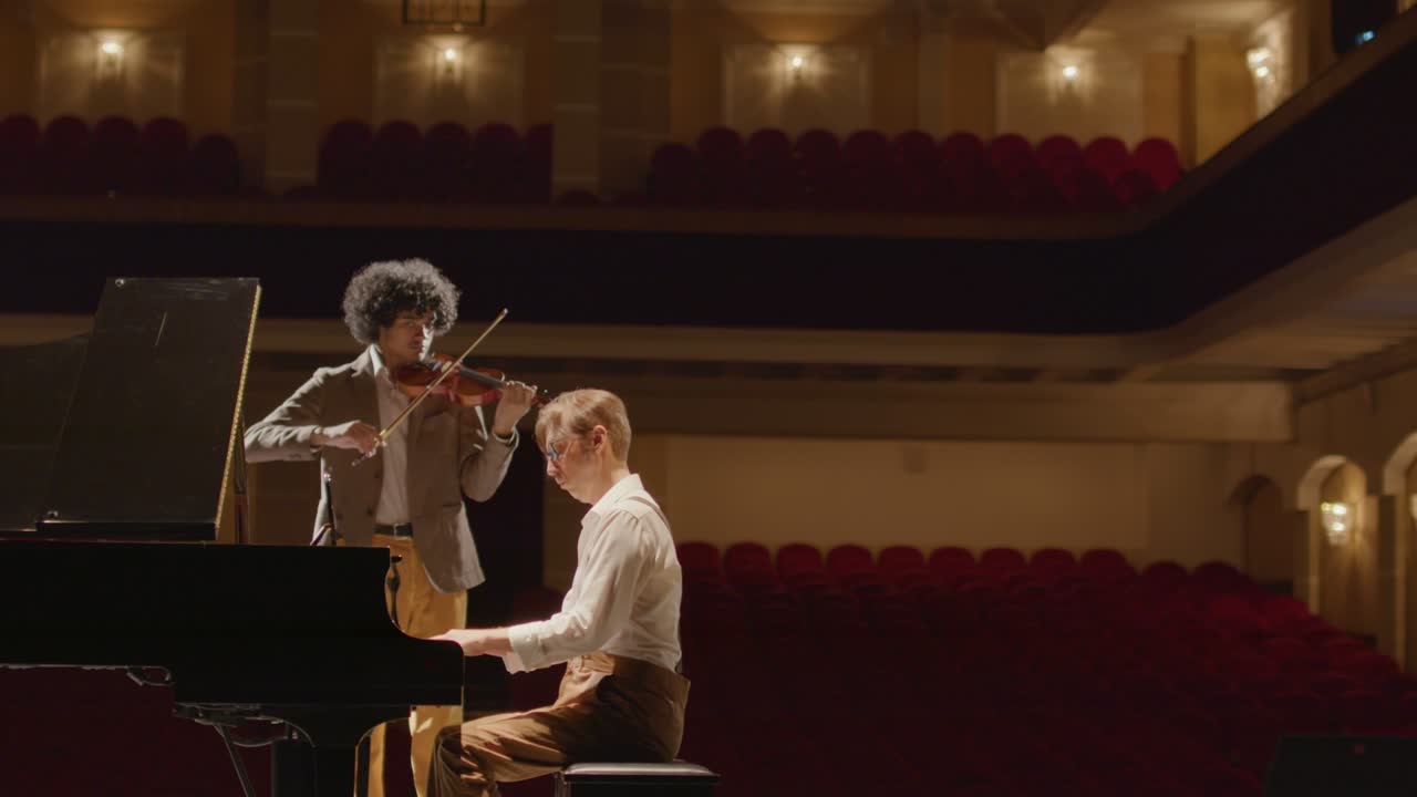 Duet Playing Violin and Grand Piano on Stage
