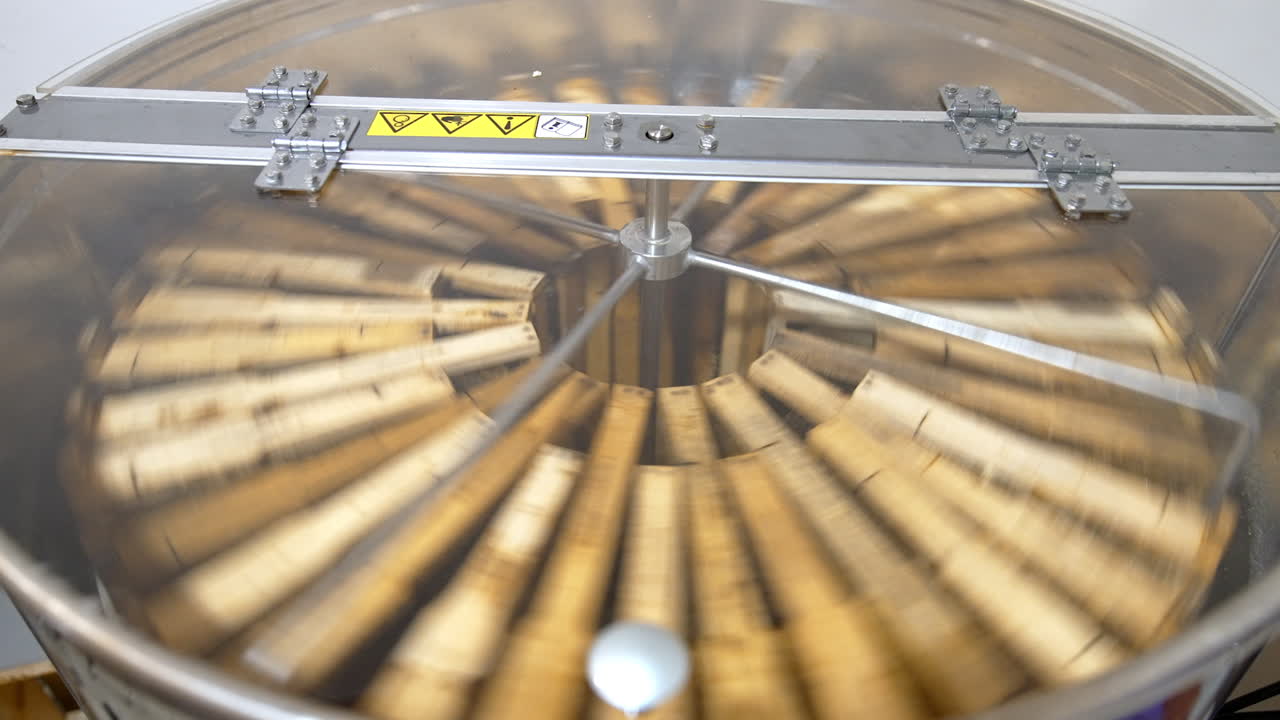 Centrifuge device rotating to pump the honey out of honeycombs. Special apiary equipment for harvesting honey.