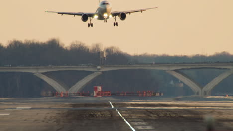 jet touches down on airport tarmac late in the day