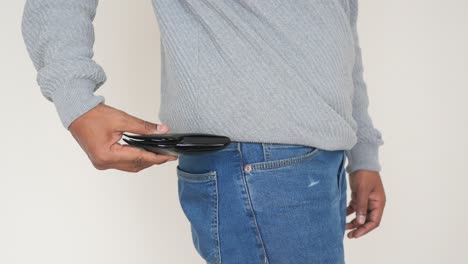 person putting a wallet in pocket