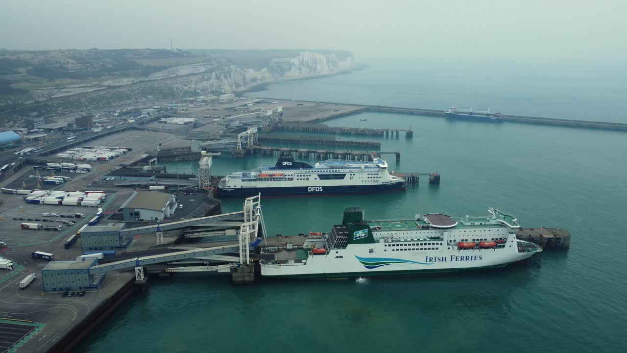 Ferry ships at port with coastal cliffs in the background