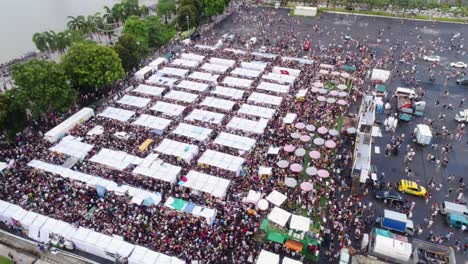 carnival and fair in singapore with thousands of people aerial shot with camera travelling in a circle point of interest shot