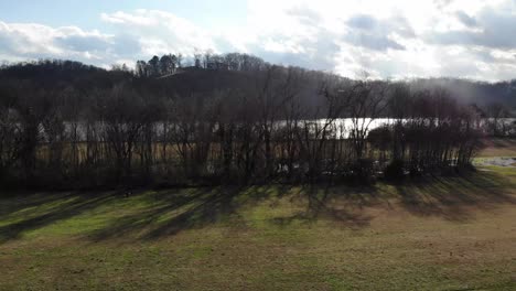 Aerial-footage-flying-up-over-trees-with-river-in-the-background