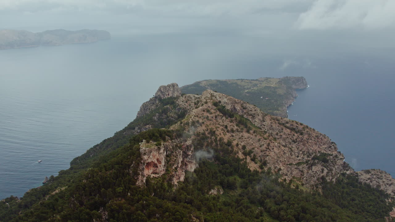 Overcast Sky Under Talaia d'Alcúdia Mountain Peaks Overlooking Punta de s' Almadrava In Mallorca Islands, Spain