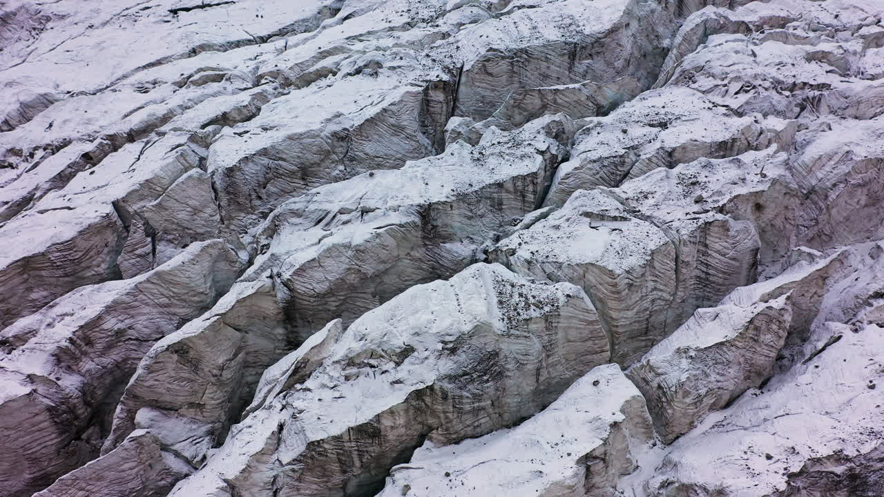 dron cinematográfico rotatorio del terreno nevado y rocoso del glaciar ak-sai en kirguistán