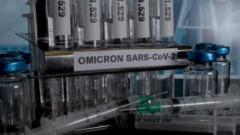 omicron sars-cov-2 test tube samples in metal rack holder. slow zoom out