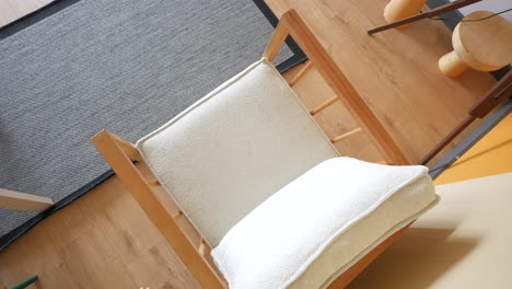 wooden armchair with white cushion in a living room