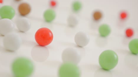 colorful round candies on white reflective surface 4k