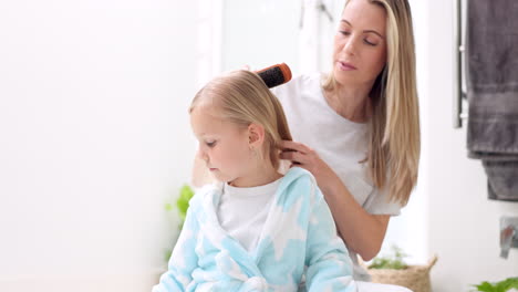 Girl,-mother-and-brush-hair-in-bathroom-home