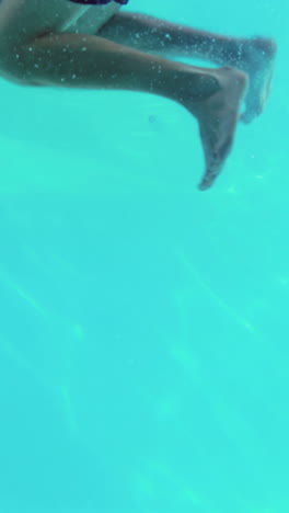 pareja feliz saltando en la piscina juntos tomados de la mano