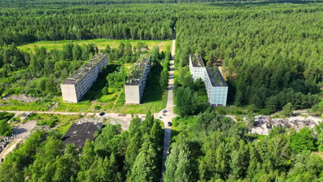 Abandoned-apartment-building-blocks,-reclaimed-by-nature,-aerial-chernobyl