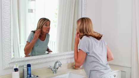 Senior-woman-stretching-in-front-of-the-mirror